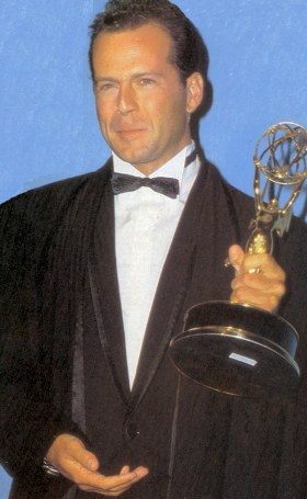 Bruce Willis holding his Emmy for 1987 Best Dramatic Actor in a Leading Role
